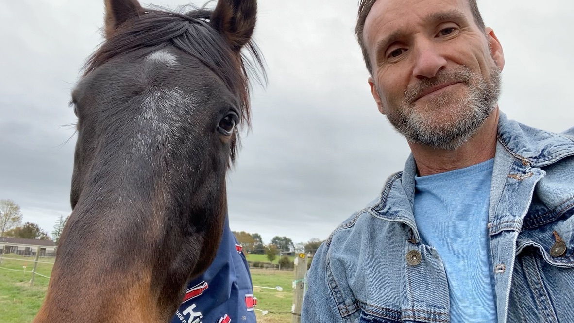 Steve Mullan with animals in a natural NZ setting